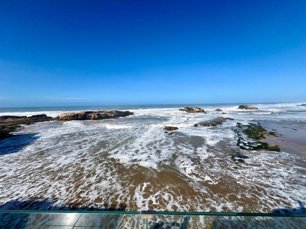 an aerial view of a beach with rocks in the water at Riad d'exception vue mer au coeur de la médina Essaouira - Mandji Dream in Essaouira