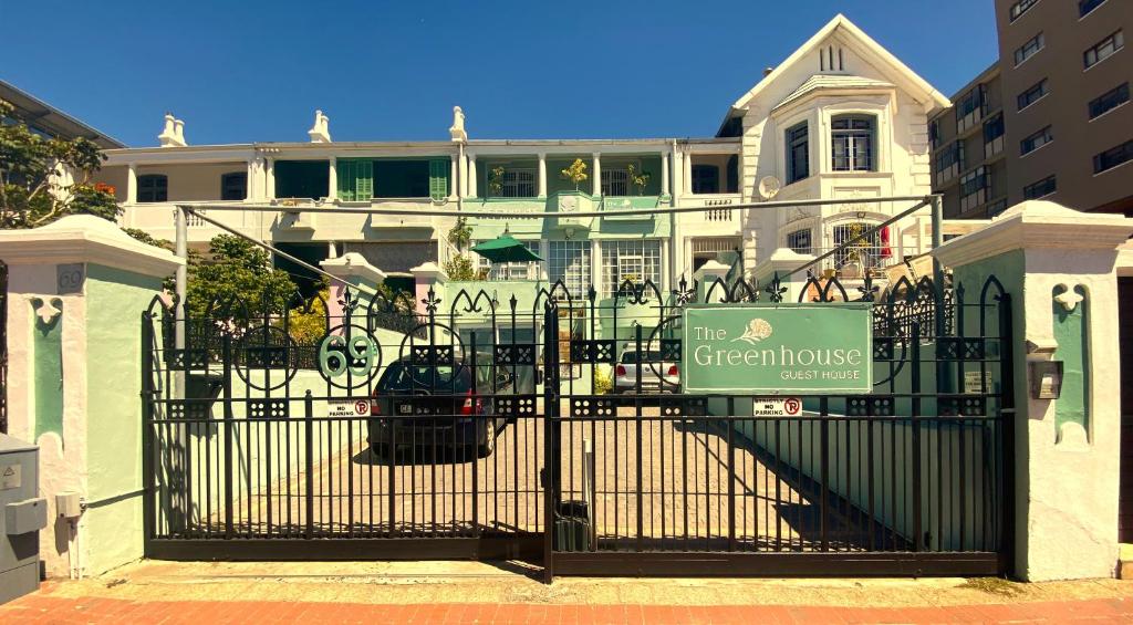 a gate with a sign in front of a house at The Greenhouse Guesthouse in Cape Town