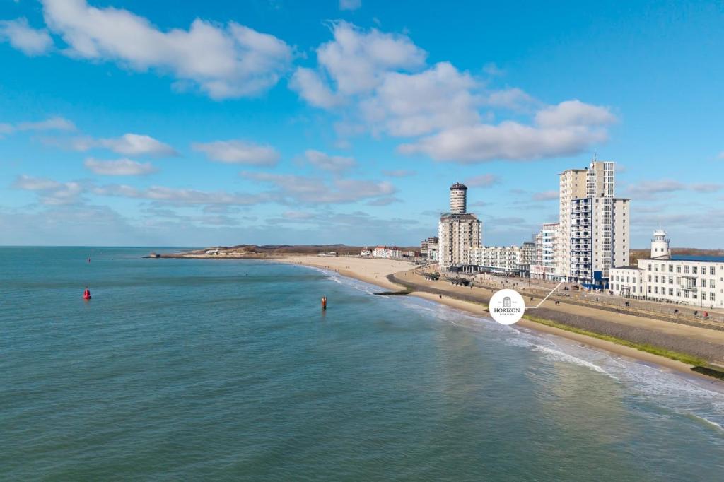 a view of a beach with buildings and the ocean at Horizon Suite at Sea in Vlissingen