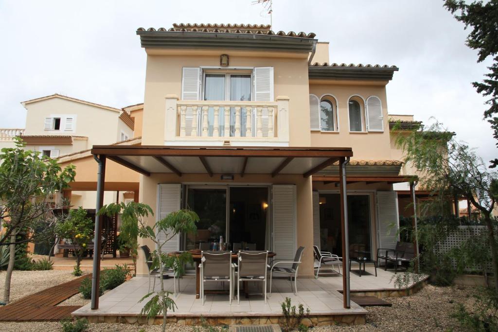 a house with a patio with chairs on it at Casa Jazmin in Cala Bona
