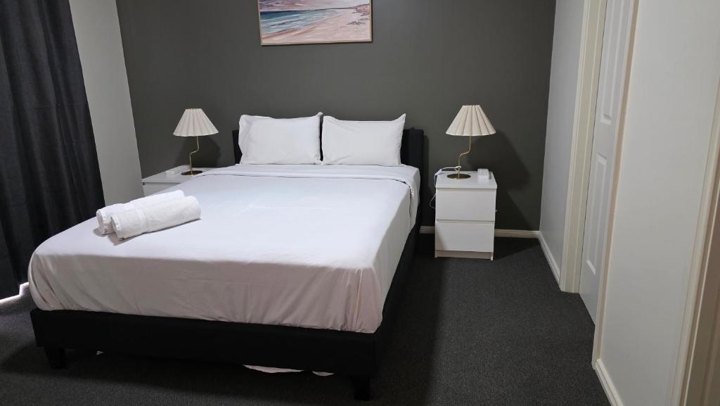 a bedroom with a large bed with two night stands at The Prospect Executive Home in Prospect