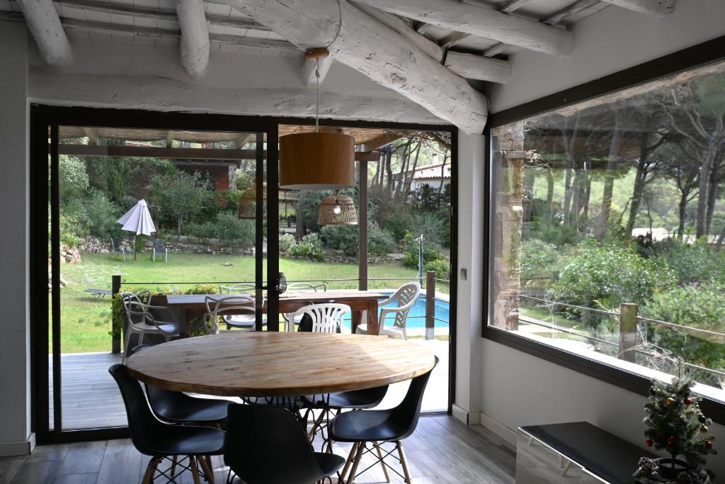 a dining room with a wooden table and chairs at Homenfun Costa Brava Begur Villa in Begur