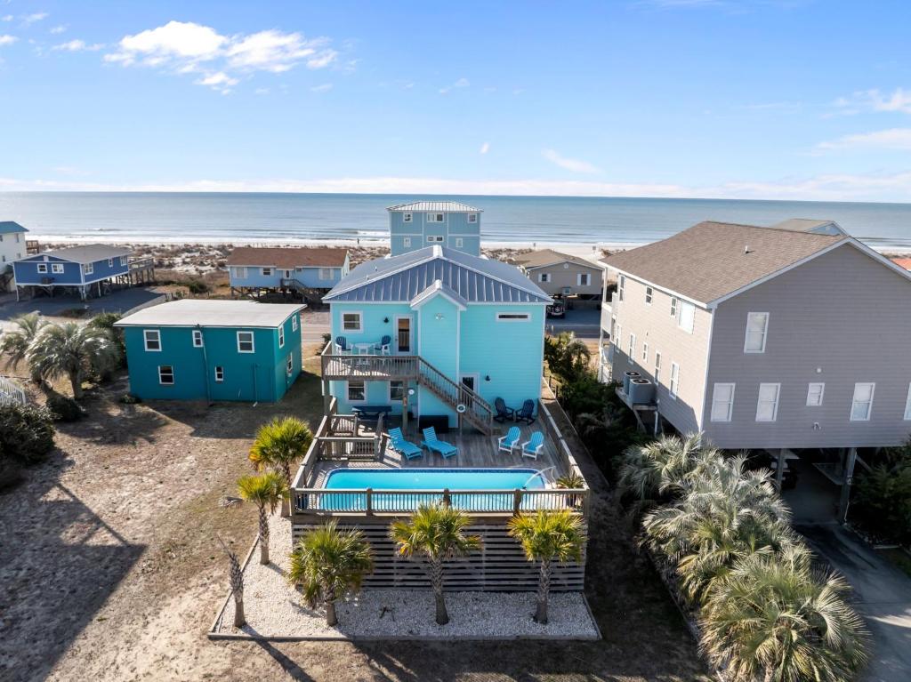 an aerial view of a beach house with a swimming pool at Ocean Views with Heated Pool One Row from Beach in Oak Island
