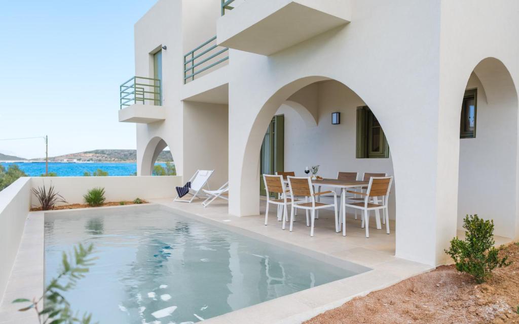 a villa with a swimming pool and a dining area at Villa Selina 3 - Etheras Properties in Kythira