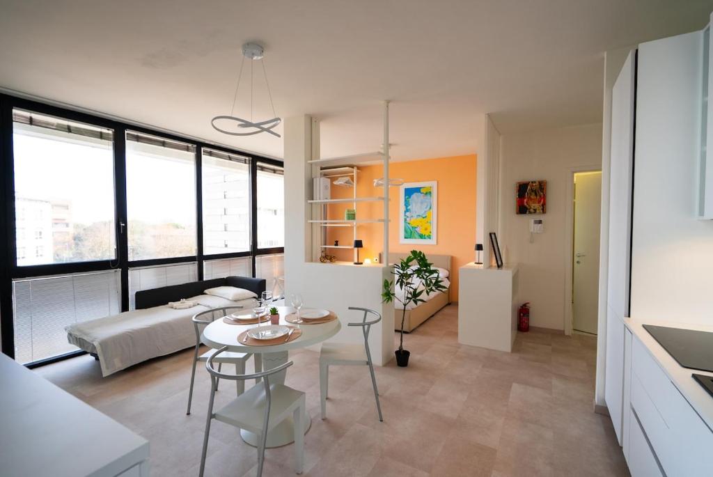 a living room with a table and a couch at Attico Belvedere Randi in Ravenna