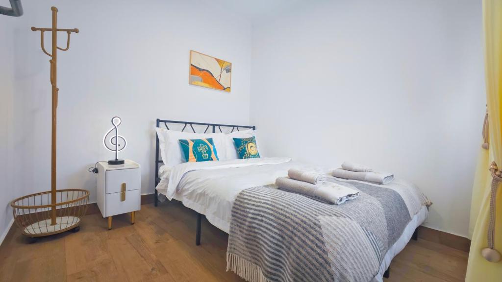 a bedroom with a bed and a cross on the wall at Cascais Garden House 102 in Cascais