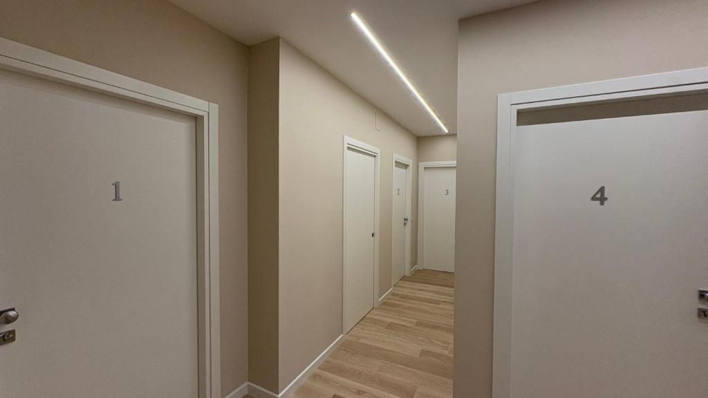 an empty hallway with four doors and a hallway at Affittacamere Nonna Maria in Foggia