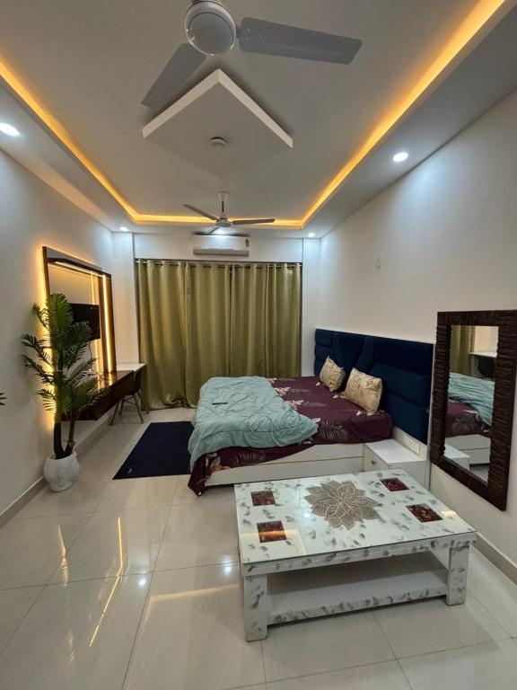 a bedroom with a bed and a couch and a table at istudio in Ghaziabad