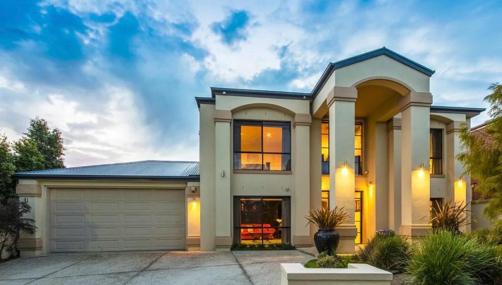 a large white house with a garage at Home in Highton in Highton