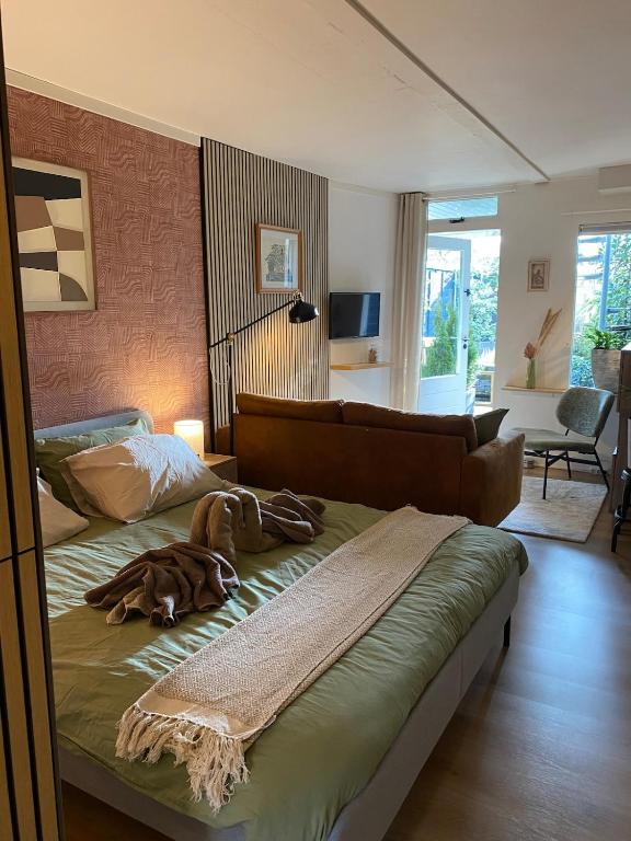 a dog laying on a bed in a bedroom at Appartement met jacuzzi in Huizen in Huizen
