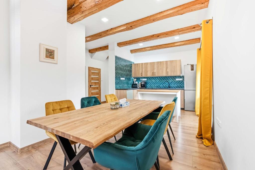 a dining room with a wooden table and chairs at Penzion Pod Vinicemi in Litoměřice
