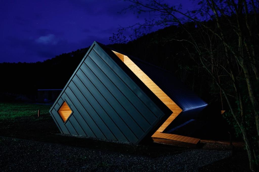 a small house sitting in a field at night at Cabin Balaton in Vonyarcvashegy