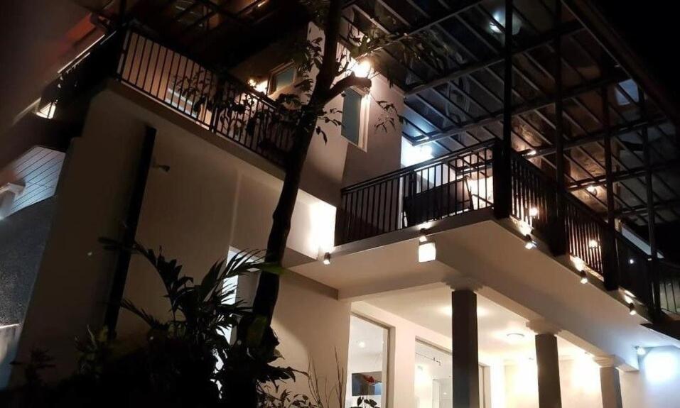 a building with a balcony with lights on it at The Villa Rochelle Kandy in Kandy