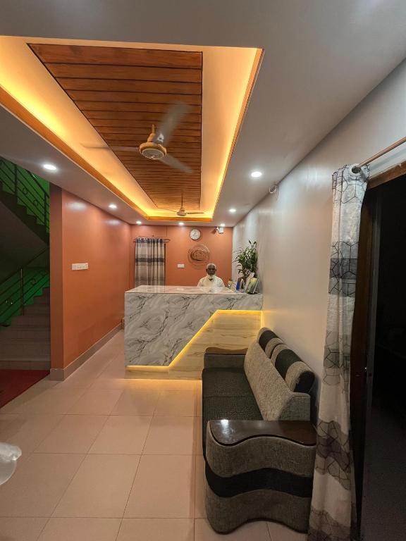 a living room with a couch and a bar at Green View Resthouse in Sreemangal