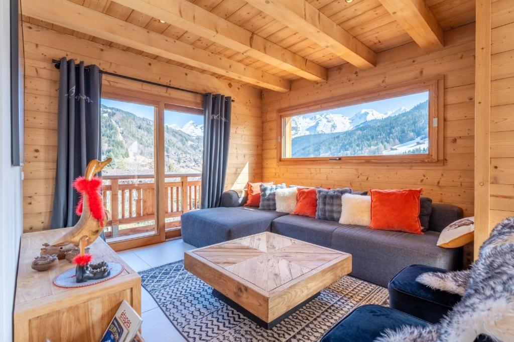 a living room with a couch and a table at Chalet BO'M in Le Grand-Bornand