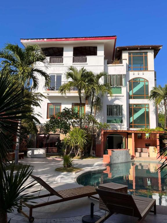 a building with a swimming pool in front of a building at Casa Mezcaleria formerly Boracay Beach Club in Boracay