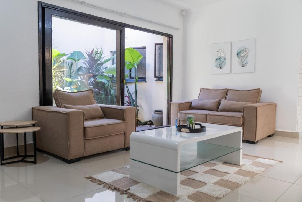 a living room with two couches and a coffee table at Windsor Place by First Private Stays in Margate