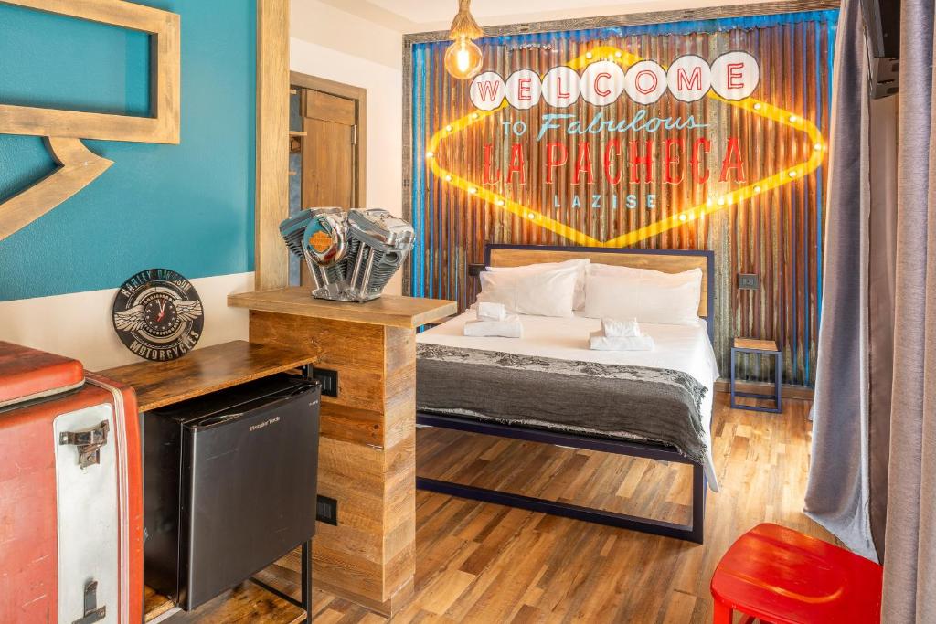 a bedroom with a bed with a sign on the wall at La Pacheca Rock Apartments in Lazise
