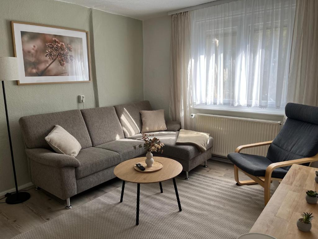 a living room with a couch and a table at house46-1 in Hohen Neuendorf
