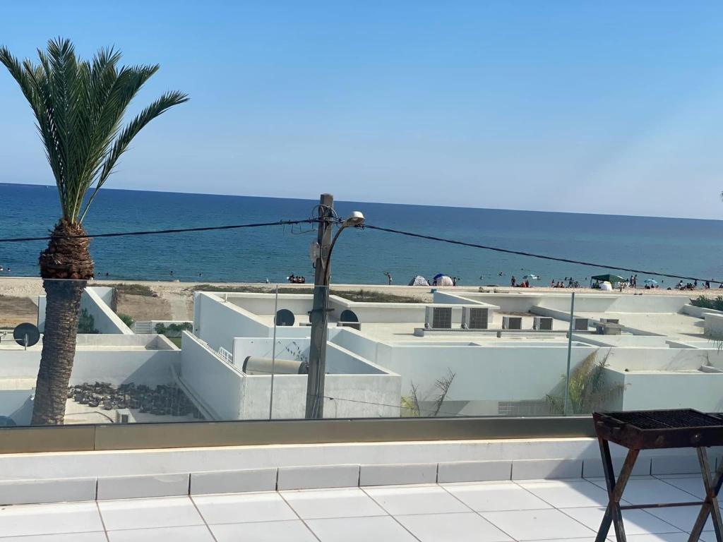a balcony with a view of the beach at Villa Sassi in Nabeul