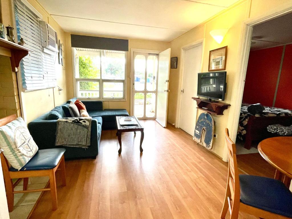 a living room with a couch and a table at Lazy Shanty in American River