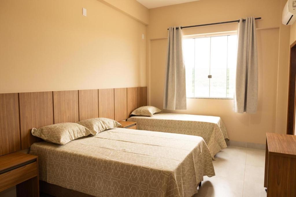 a bedroom with two beds and a window at Hotel Primavera Palace in Salinas