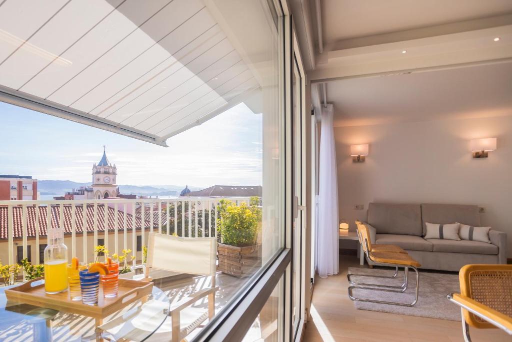 a balcony with a couch and a view of the city at Santa Teresuca en Santander in Santander