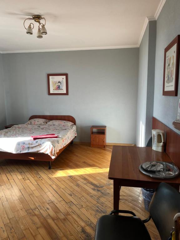 a bedroom with a bed and a table in it at Міні готель вулиця Чавдар in Kyiv
