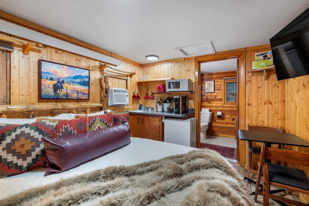 a living room and kitchen in a log cabin at Timber Ridge Cabin: Rustic Getaway in Rapid City