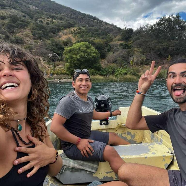 a group of people sitting on a boat in the water at Patziapa in Santiago Atitlán