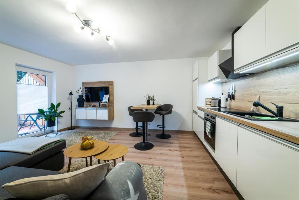 a living room with a couch and a table at Ferienwohnung TaJoLe in Heinade
