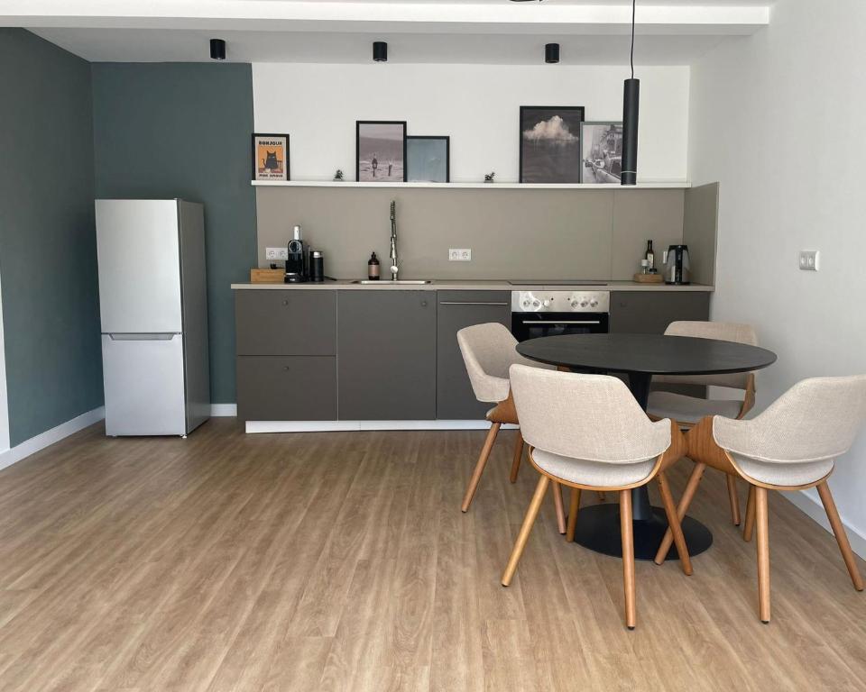 a kitchen with a table and chairs and a refrigerator at Superior Apartment mit 1 Schlafzimmer in Hildesheim