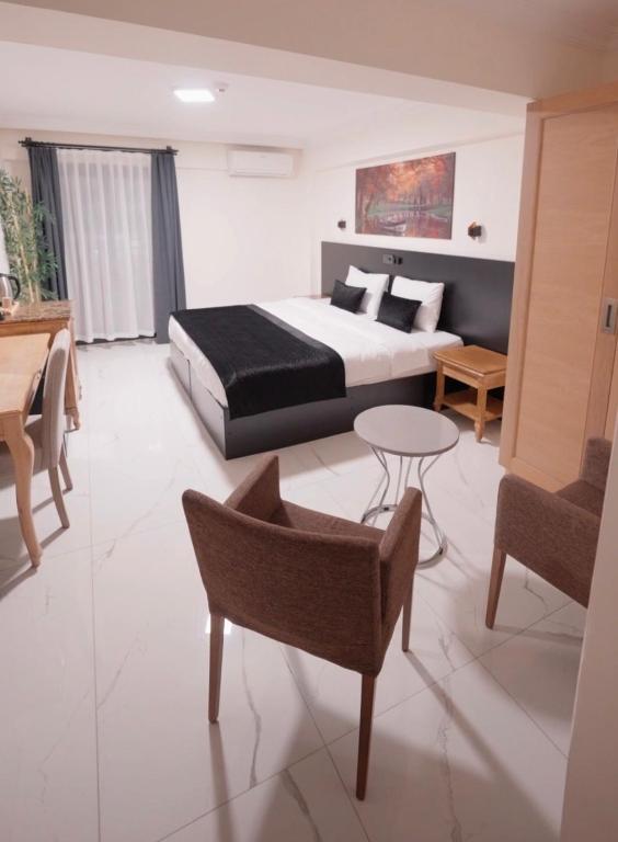 a hotel room with a bed and a table and chairs at La Vista in Gaziemir