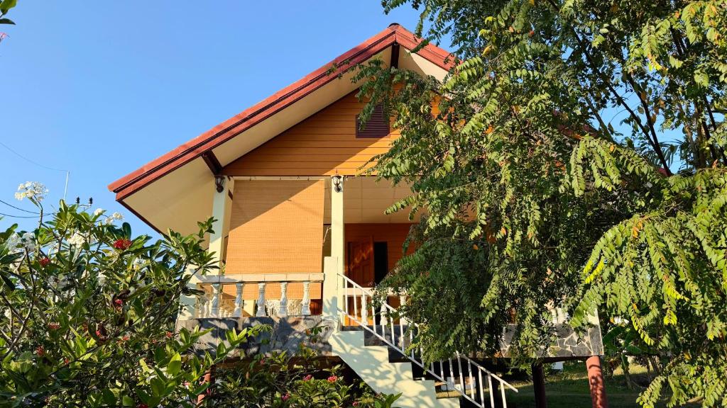 a house with a red roof and stairs to it at Chill House in Ko Phangan