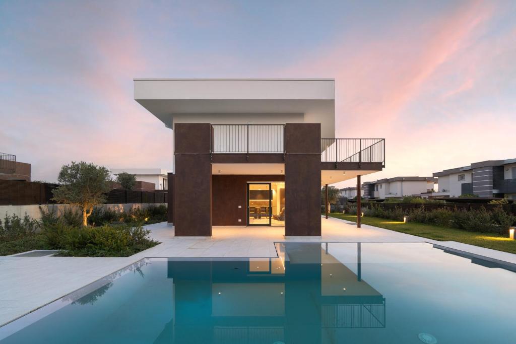 a house with a pool in front of it at NNV Pool Villa Lazise in Lazise