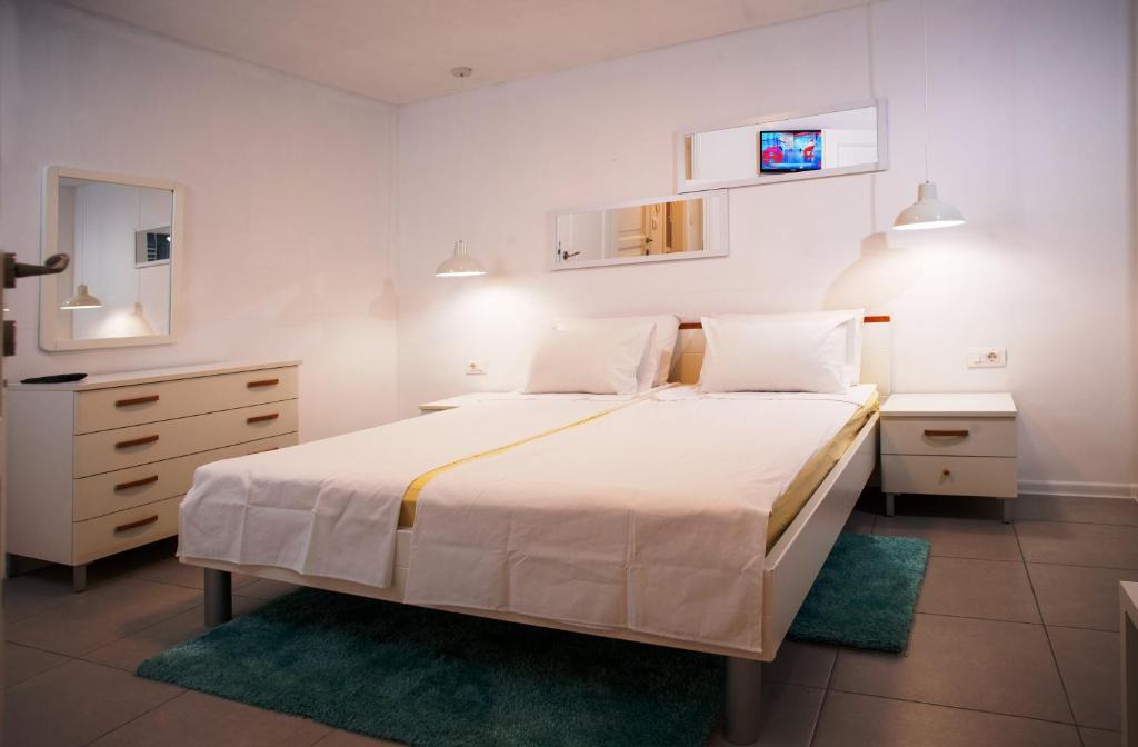 a bedroom with a large bed and a dresser at DeLuxe Afrodita Apartment in Rovinj