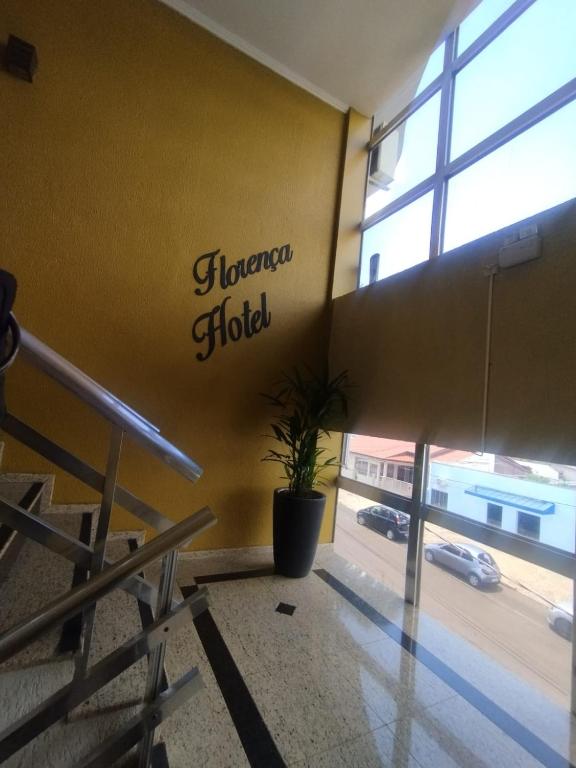a lobby with a sign on the wall of a hotel at Florença Hotel in Quedas do Iguacu