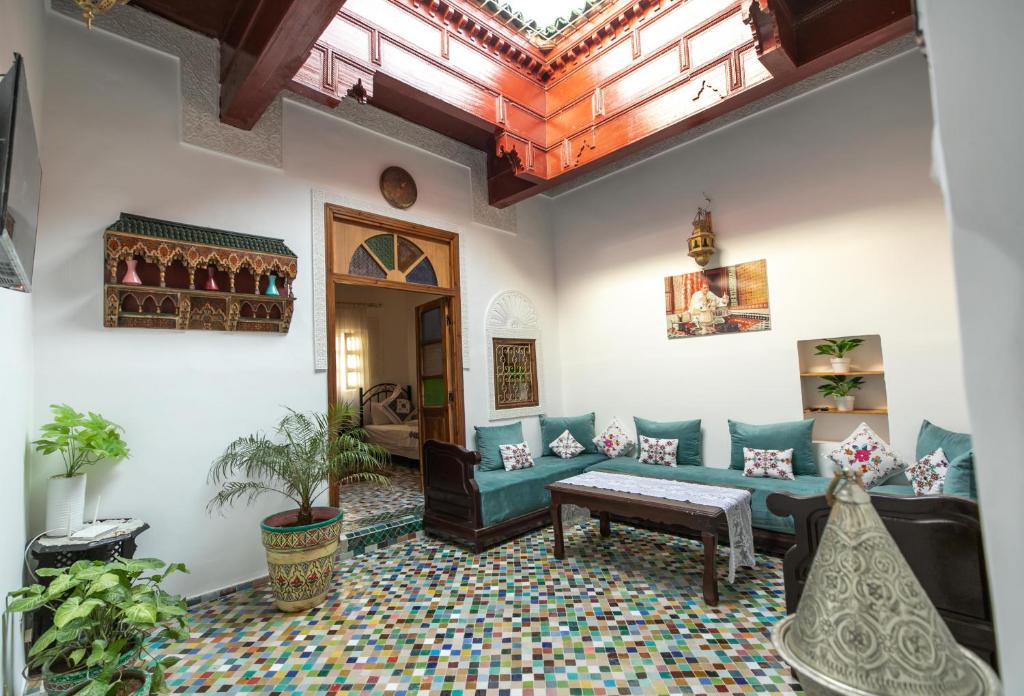 a living room with a couch and a table at Dar El Kendil in Fez