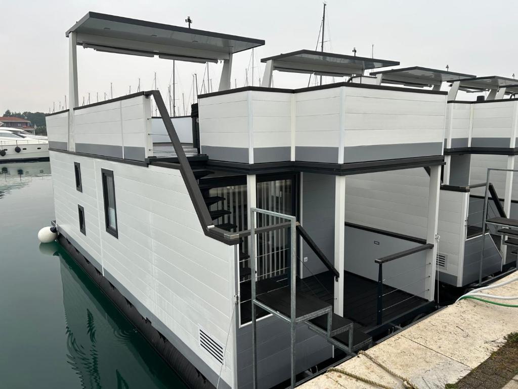 a house on a boat in the water at Hausboot Santa Lucia Novigrad - Floating Sea House in Novigrad Istria