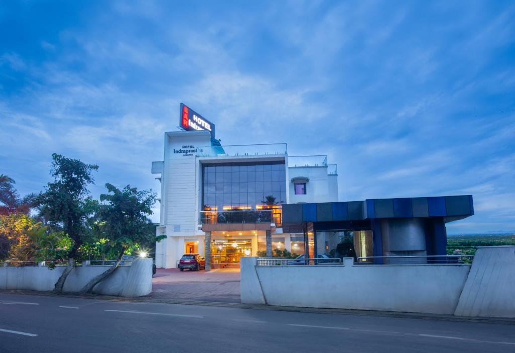 a building with a sign on top of it at Hotel Indraprastha Thiruvalla in Talavadi