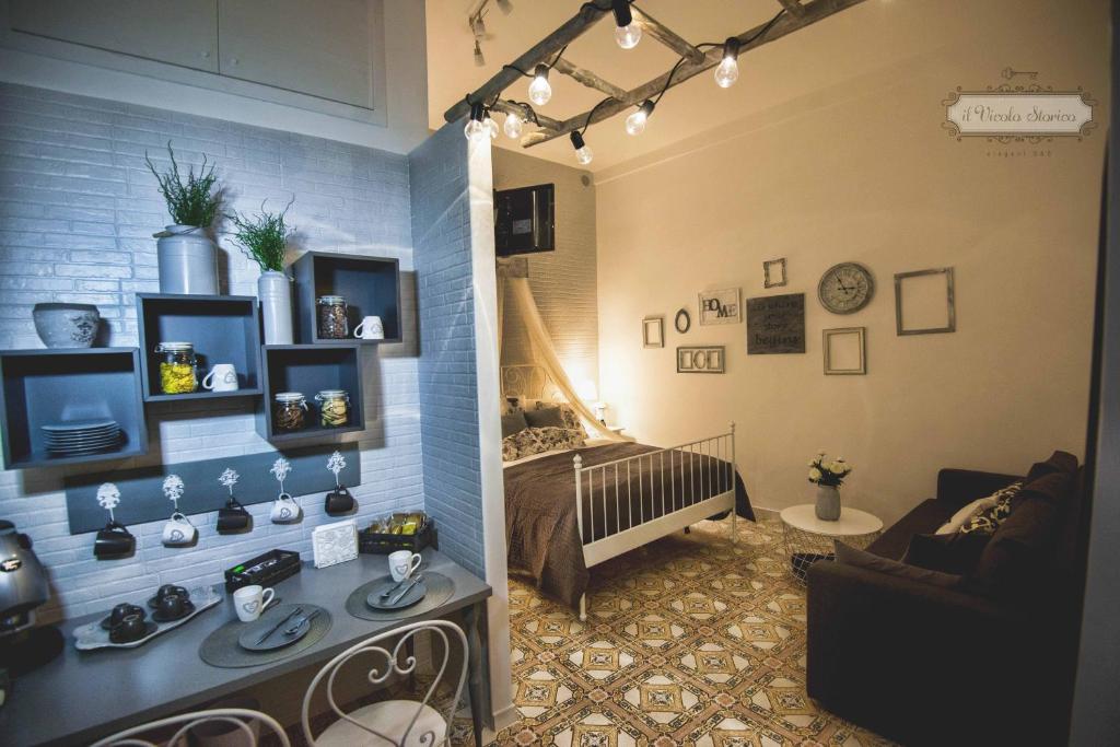 salon z kanapą i łóżkiem w pokoju w obiekcie Elegant B&B - Il Vicolo storico w mieście Salerno