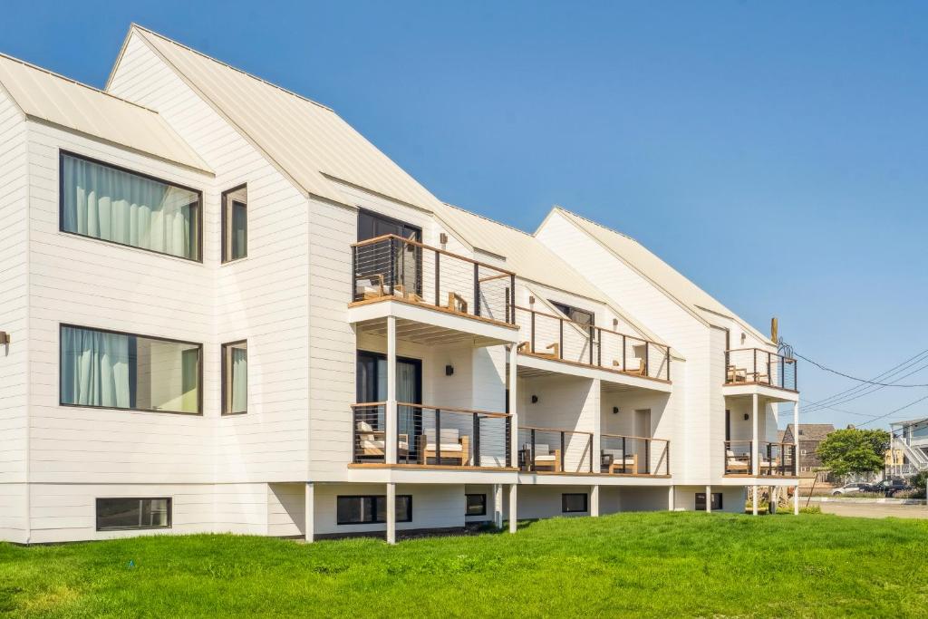 an exterior view of a white building with balconies at Offshore Spa & Residences in Montauk