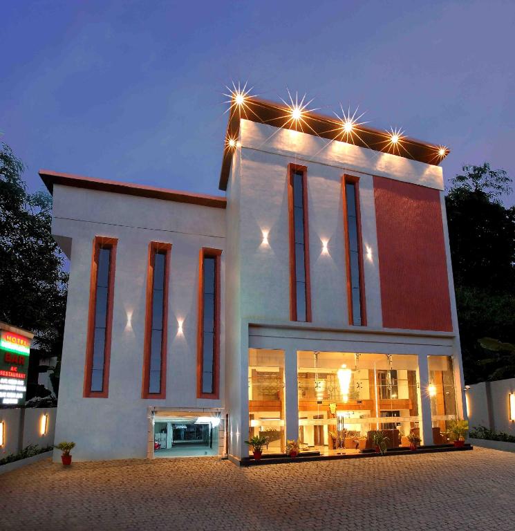 a building with lights on top of it at night at Hotel Indraprastha Karunagapally in Panmana
