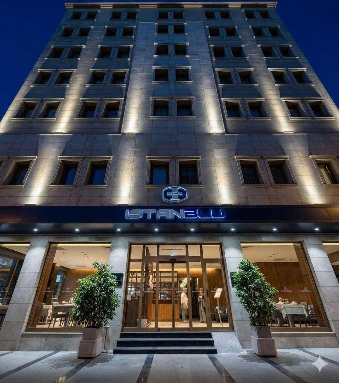 a building with a sign on the front of it at İstanblu Hotel&Spa in Konak