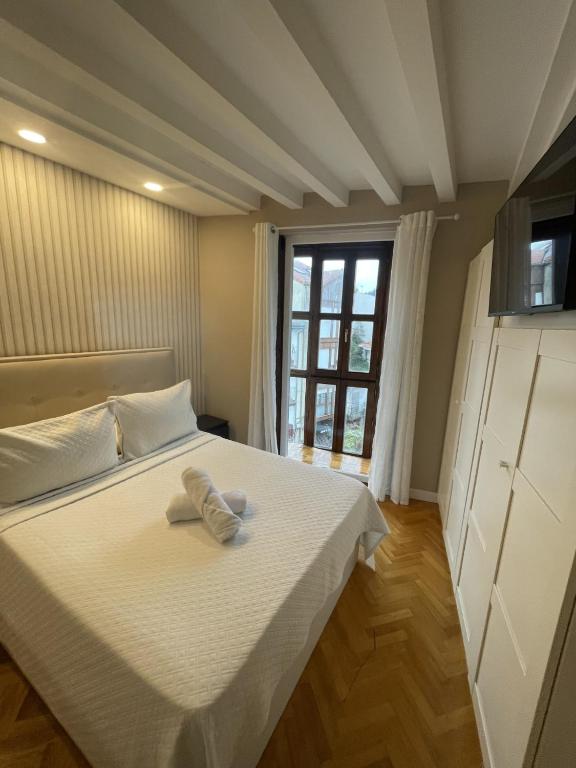 a bedroom with a bed with two towels on it at Apartamentos Castro Urdiales Centro con Parking in Castro-Urdiales