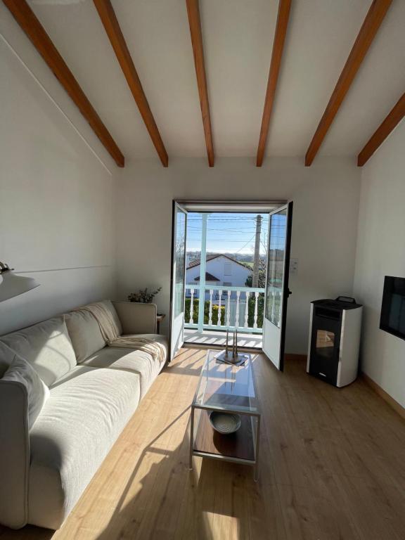 a living room with a couch and a table at Bahía de Pedreña in Pedreña
