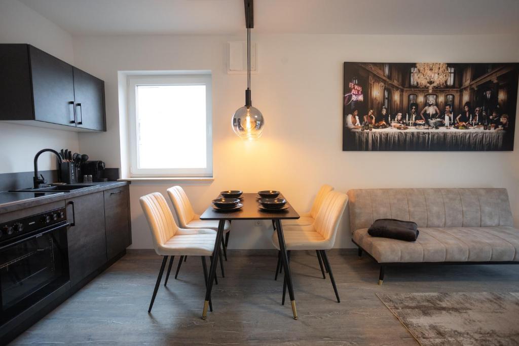 a kitchen with a table and chairs and a couch at Signature Suites Sauerland in Winterberg