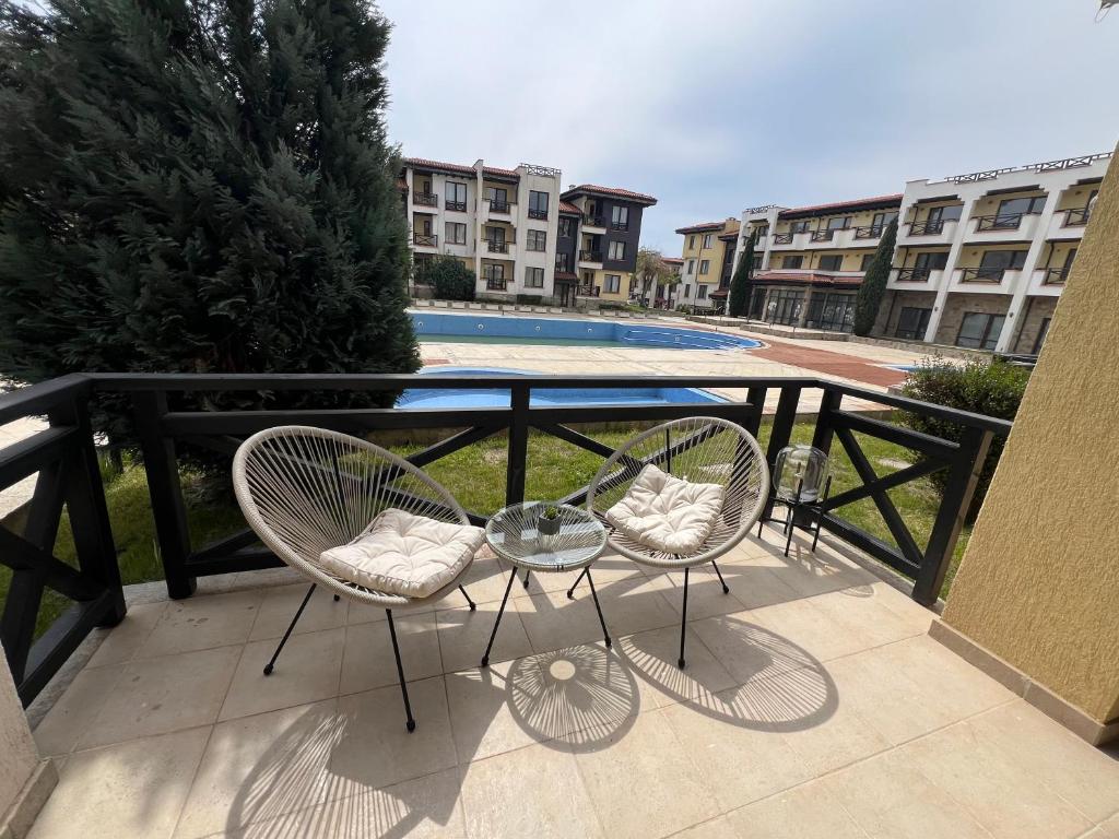 two chairs and a glass table on a balcony at Apartment N 1 in Chernomorets