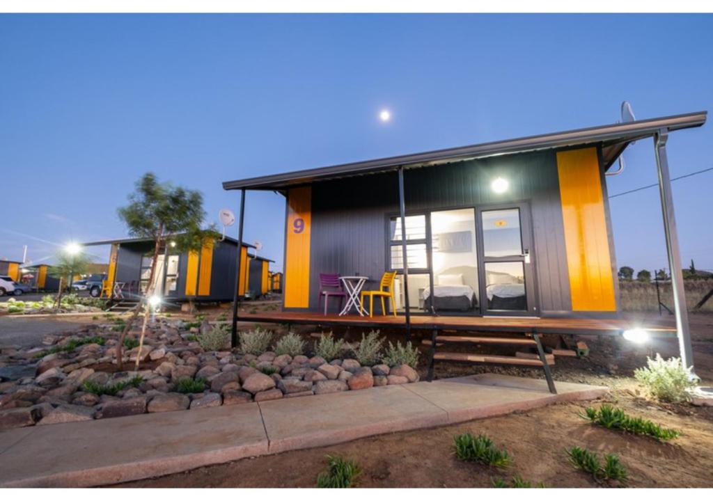 a tiny house with a bench in front of it at SleepOver Colesberg in Colesberg