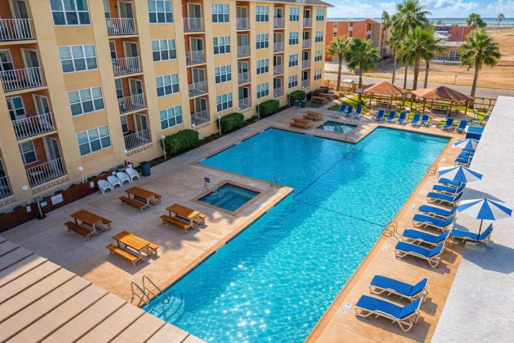 an overhead view of a swimming pool at a hotel at Beach Access Condo with Pool, Hot Tub Area & BBQ - Gulfview I - unit 213 in South Padre Island